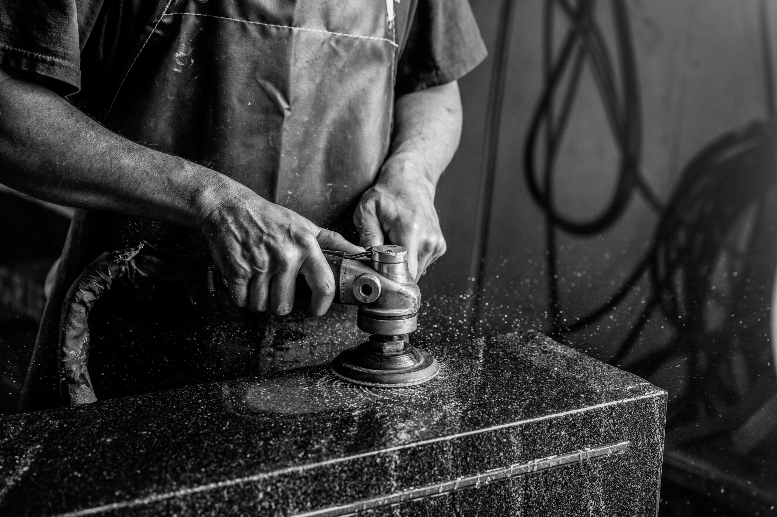 About us - Our committment Polishing a tomb stone.