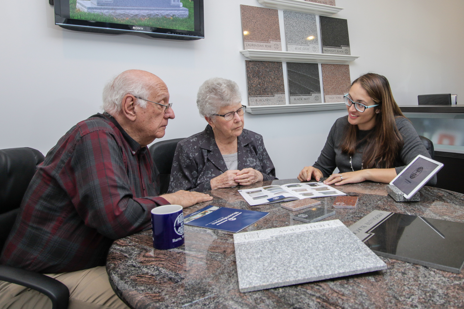 Courier-Banner-Image Elderly couple talking with Weaver Memorial rep about monument options