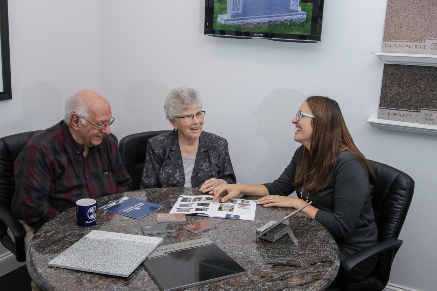 Courier-Services Elderly couple reviewing monument options with a Weaver Memorials rep